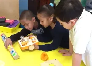 Three kids using KIBO for STEAM Learning Image